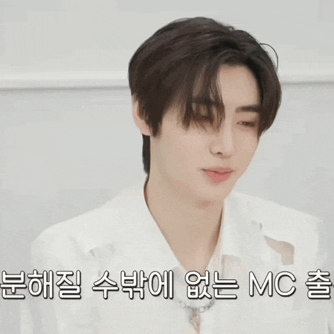 a young man wearing a white shirt and a chain around his neck says mc
