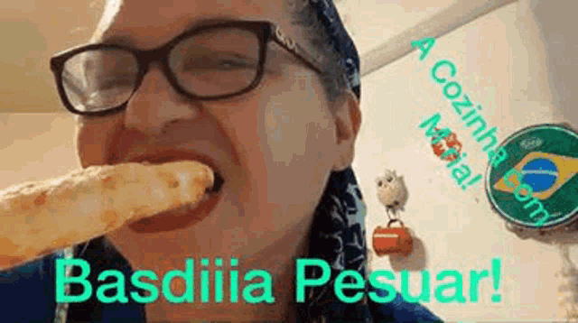 a woman wearing glasses and a bandana is eating a piece of bread .