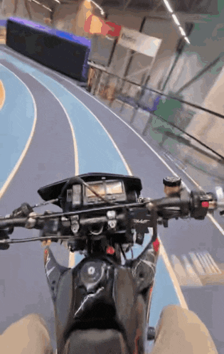 a person riding a motorcycle on a track with a sign in the background that says ' dominion '