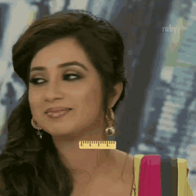 a woman with a ruler around her neck that says rubyy on it