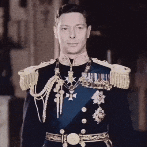 a man in a military uniform with medals around his neck looks at the camera