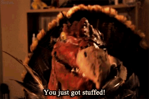 a stuffed turkey says " you just got stuffed " in a dark room