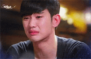 a close up of a man 's face with tears coming out of his eyes .