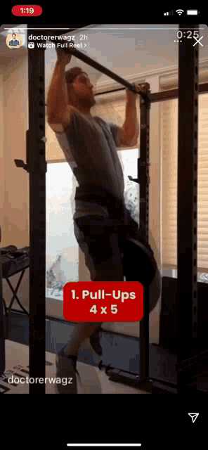 a man is doing pull ups on a bar on a cell phone