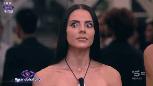 a woman is on a television screen with the words grande fratello