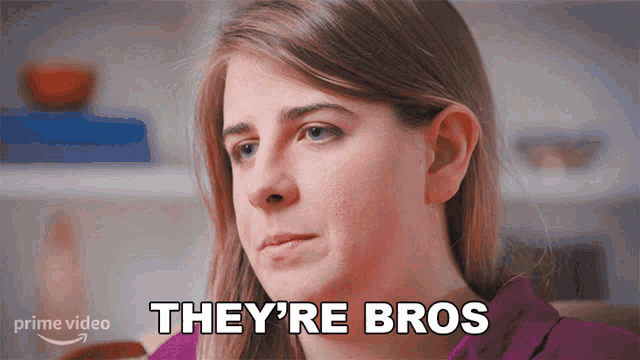 a woman sitting on a couch with the words they 're bros on her face