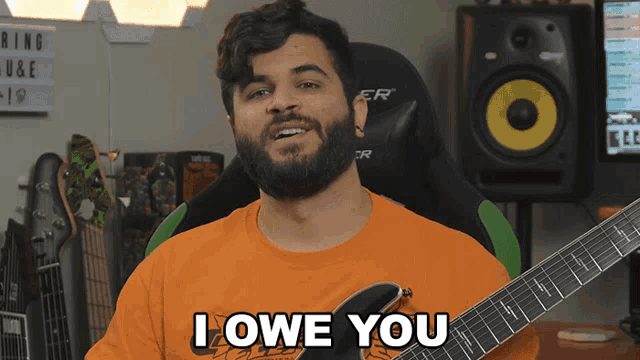 a man holding a guitar with the words i owe you on it