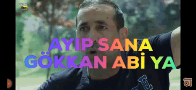 a man in a black shirt with the words ayip sana gokken abi ya behind him