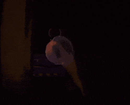 a jellyfish is floating in the dark and glowing in the dark