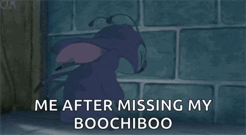 a cartoon character is sitting in front of a brick wall .