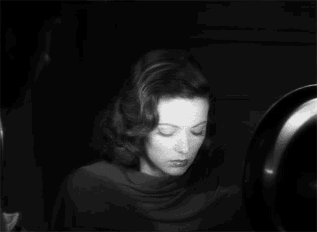 a black and white photo of a woman with a serious look on her face