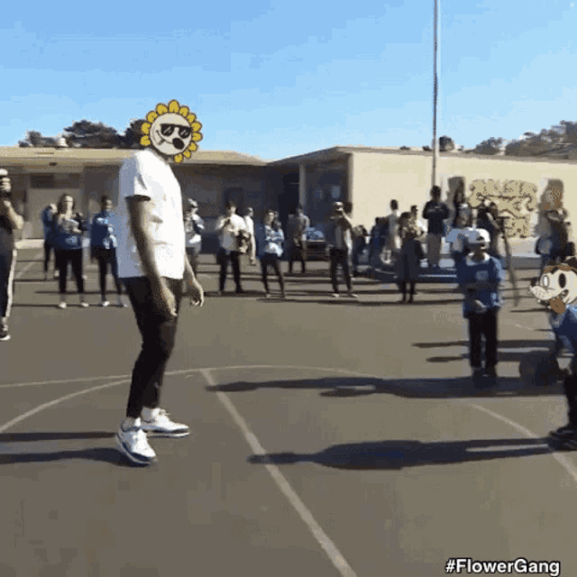 a man with a sunflower on his head is standing on a basketball court