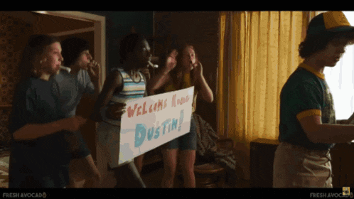 a group of people are holding a sign that says welcome home dustin