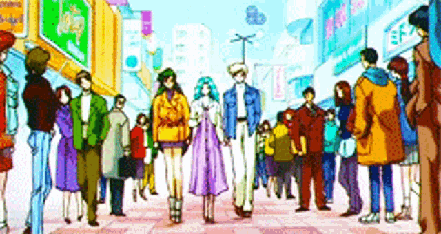 a group of people are walking down a street in a city .
