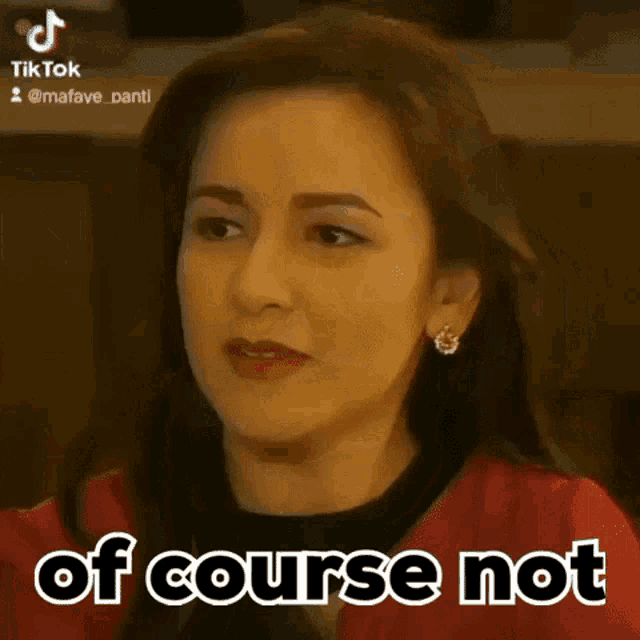 a woman is wearing a red jacket and earrings and says of course not