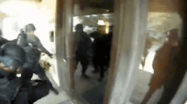 a group of police officers are standing in a room .