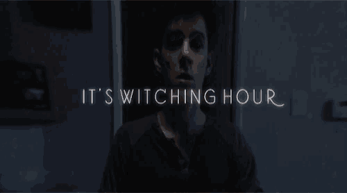 a man in a dark room with the words it 's switching hour written above him