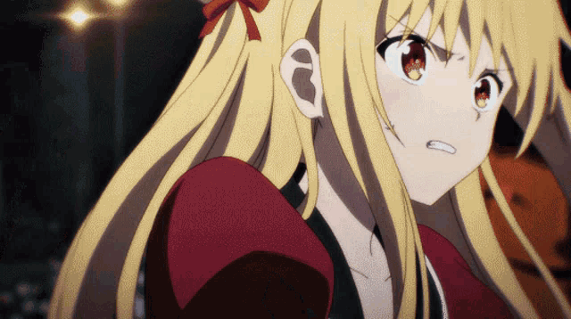a girl with blonde hair and red eyes is wearing a red top
