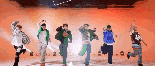 a group of people are dancing together on a stage .
