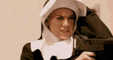 a nun is holding a gun in her hand and making a funny face .