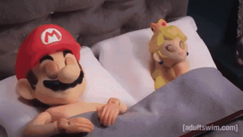 mario and princess peach are sleeping in a bed together .