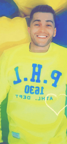 a man wearing a yellow shirt that says j.h. 9