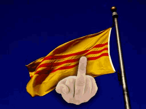 a hand is giving the middle finger in front of a yellow flag