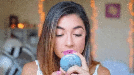 a woman is eating a donut with a pink lipstick on her lips .