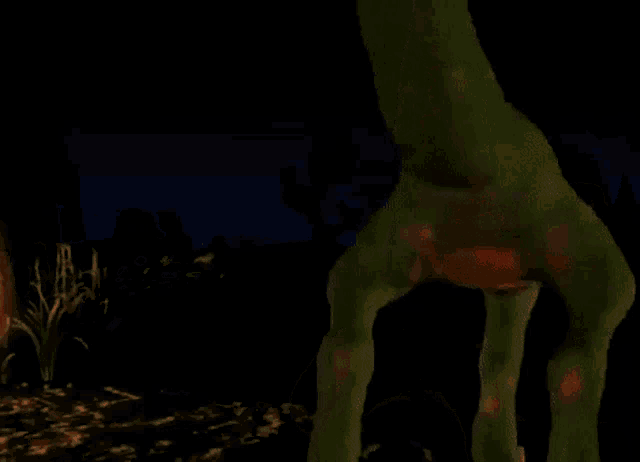 a green dinosaur with red stripes on its tail