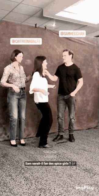 a man and two women are dancing in a room with a sticker that says sam heughan