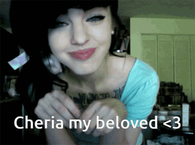a woman with a tattoo on her chest says cheria my beloved