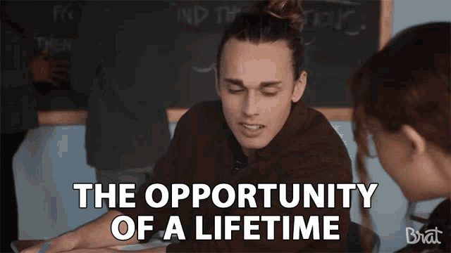 a man sitting in front of a blackboard with the words " the opportunity of a lifetime " on it