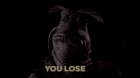 a close up of a monster 's face with the words `` you lose '' in yellow letters .