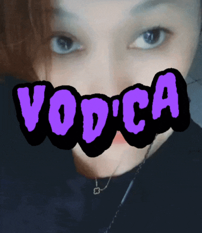 a woman 's face is behind a purple sign that says vodka