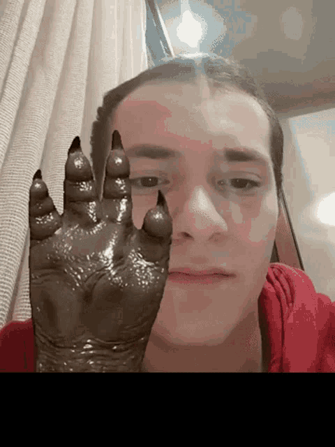 a close up of a man 's face with a claw in front of his face