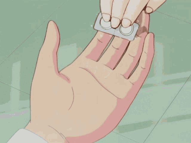 a person is holding a pill in their hand that says ' co ' on it