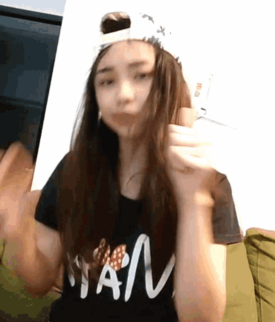 a girl wearing a black shirt that says " nan "