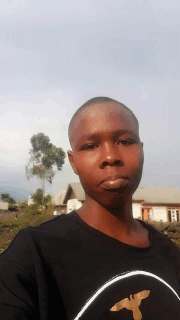 a young man taking a selfie with a house in the background .