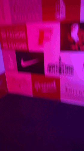 a blurred image of a wall with pink and red squares and a nike logo
