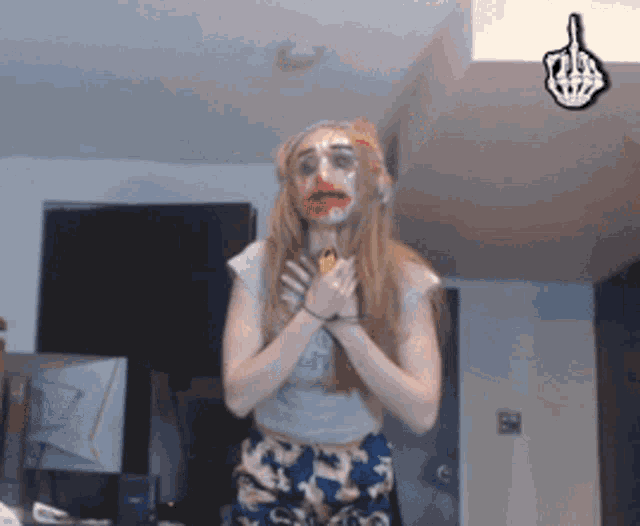 a woman with red paint on her face is holding a banana