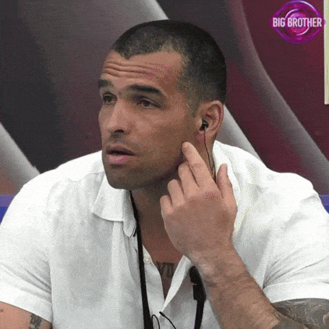 a man is wearing ear buds and has a big brother logo behind him