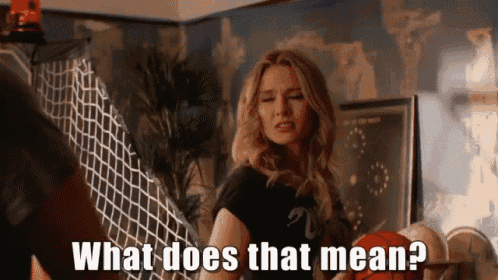 a woman is asking what does that mean while standing in a room .