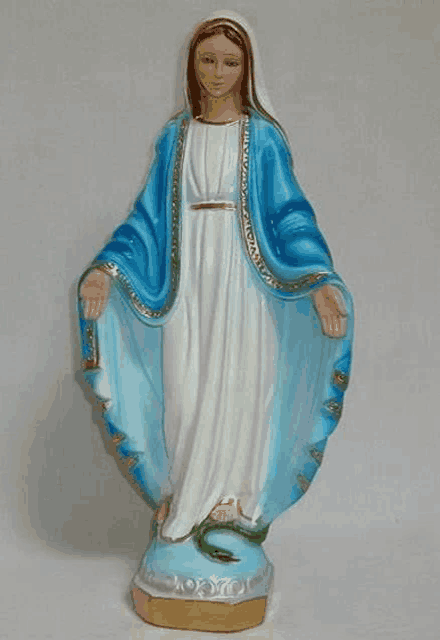 a statue of the virgin mary with a blue robe and white dress