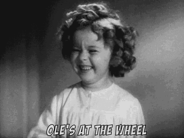 ole 's at the wheel is written on a black and white photo of a little girl
