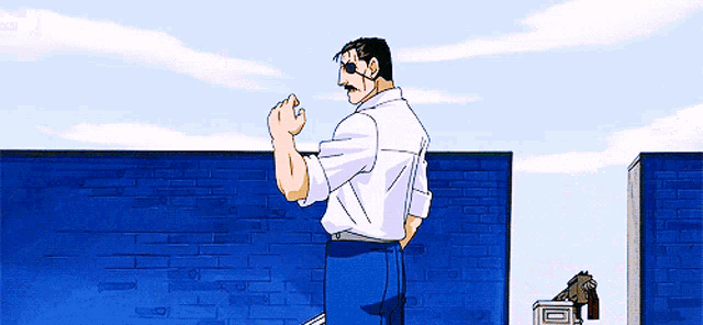 a man in a white shirt and blue pants stands in front of a blue wall