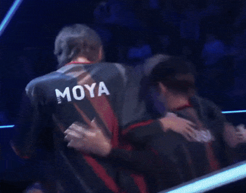 two men hugging each other with their heads together