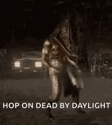 a pyramid head from silent hill is standing in the dark .