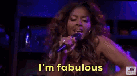 a woman singing into a microphone with the words i 'm fabulous written on the bottom