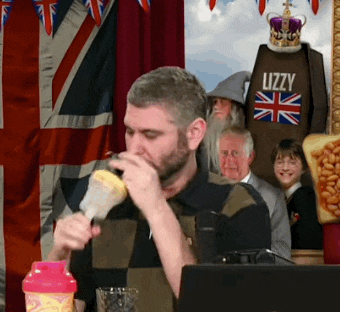 a man is drinking from a pink bottle while wearing a shirt that says lizzy on it