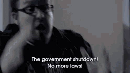 a man wearing glasses is talking about the government shutdown and no more laws .